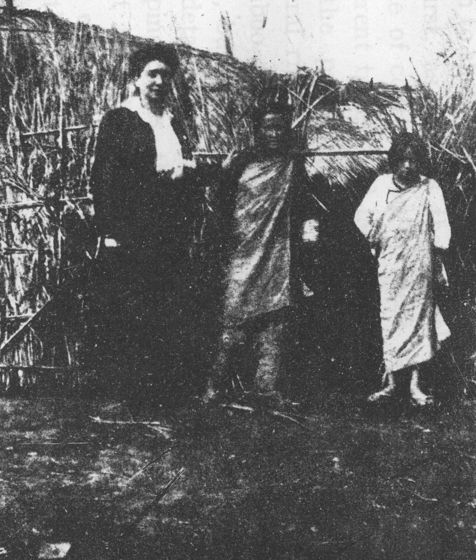 珍妮（左一）和兩位泰雅族女孩於泰雅族房舍前留影。
